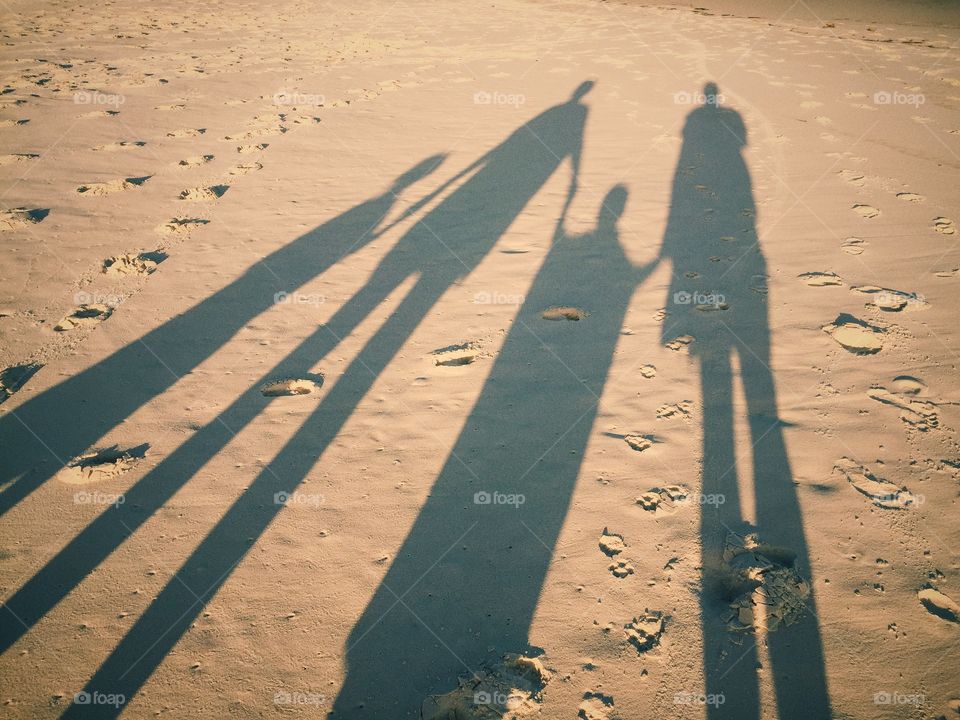 Family silhouettes down at the beach