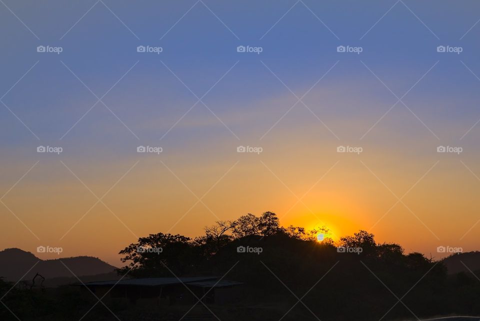 Sunrise with radiant sunshine in the mountains