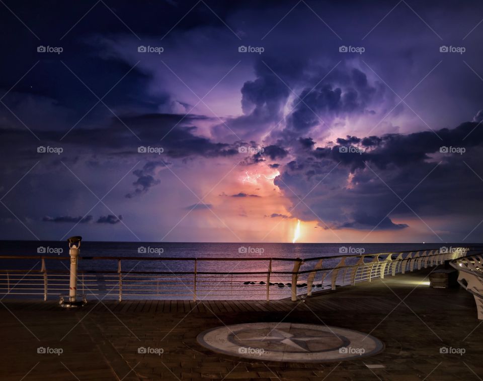 Thunderstorm and lightning over the sea at night