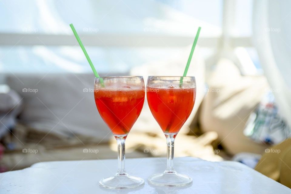 Red summer soft drink in glass goblets.