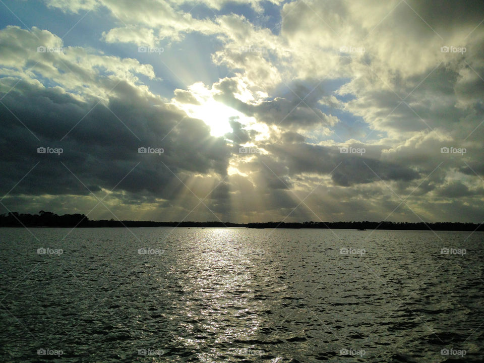 Sunlight through the clouds over sea