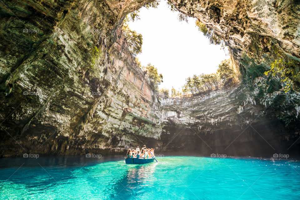 People With Wooden Boat Visit Famous Cave Lake Melissani In Kefalonia Greek Island