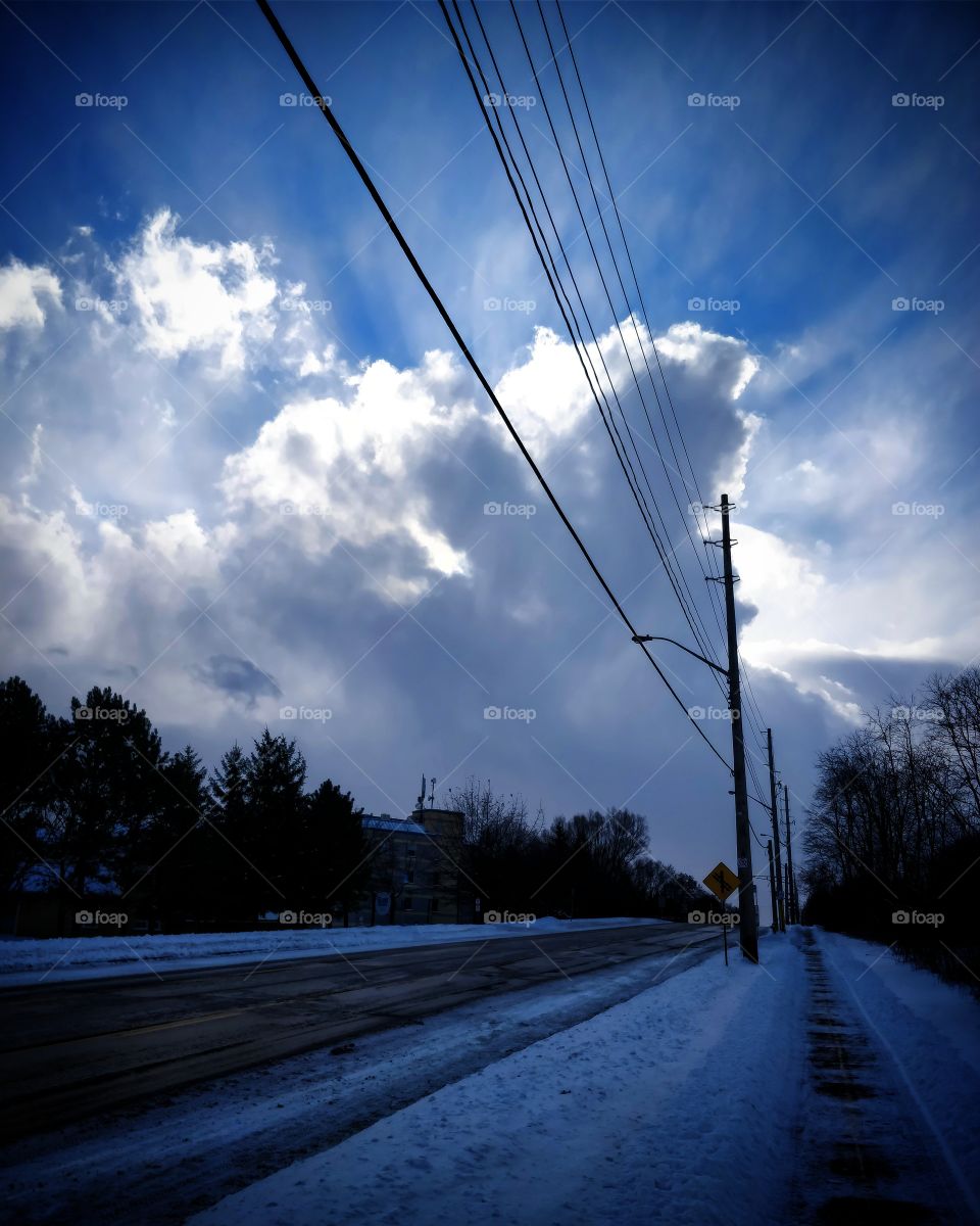 Winter walks in the city with beautiful sunlight beaming behind the clouds