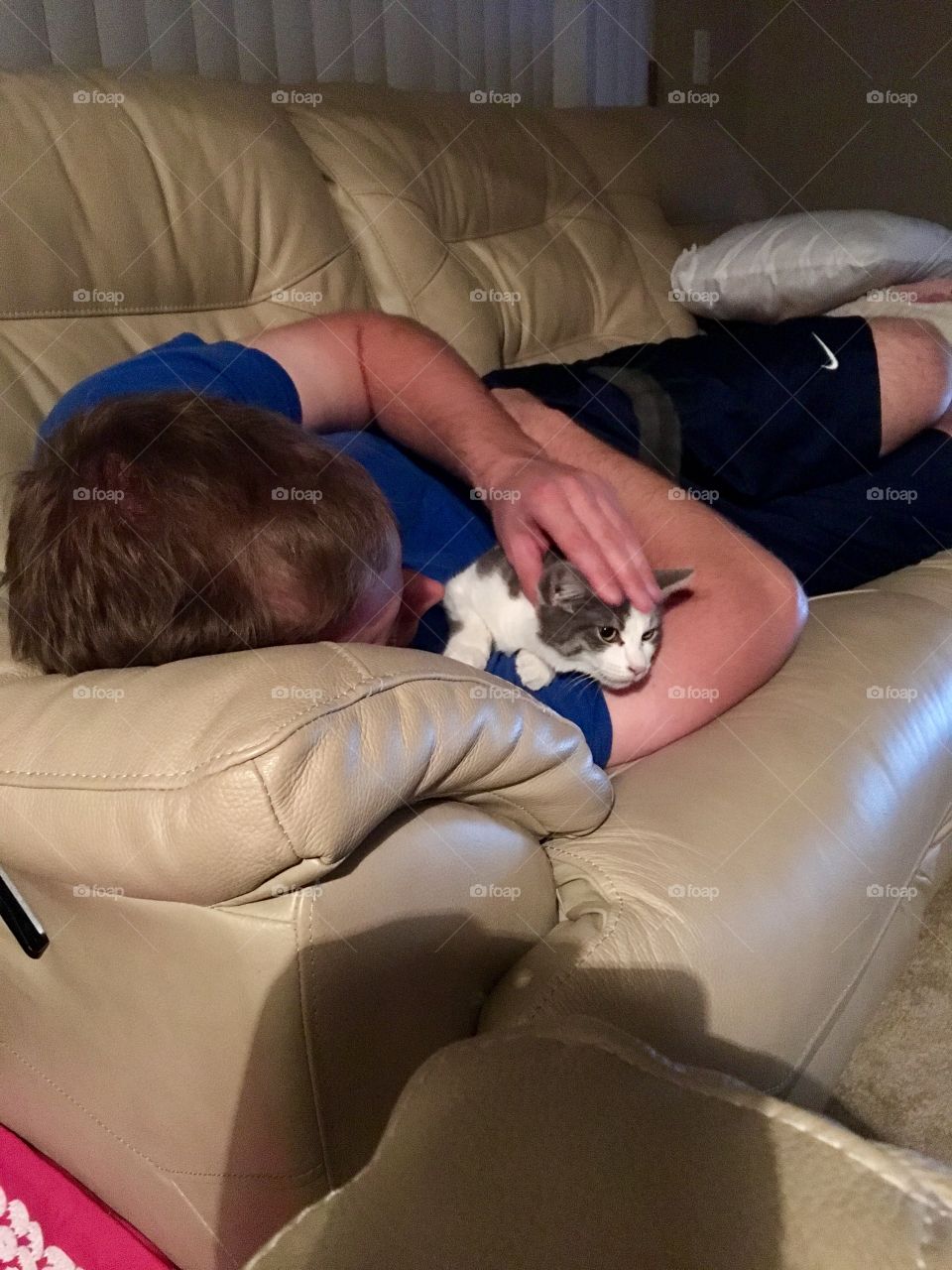After a long day at work he likes to snuggle up on the couch with his kitties