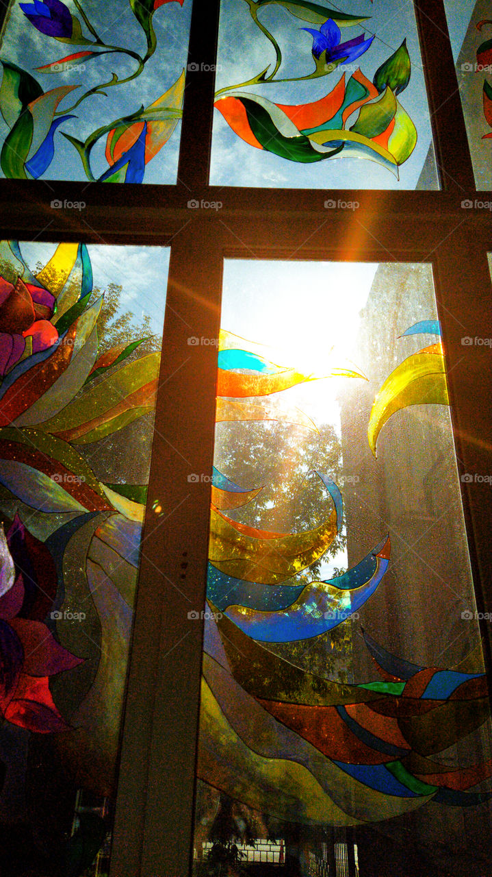 A ray of light that enters a stained glass window