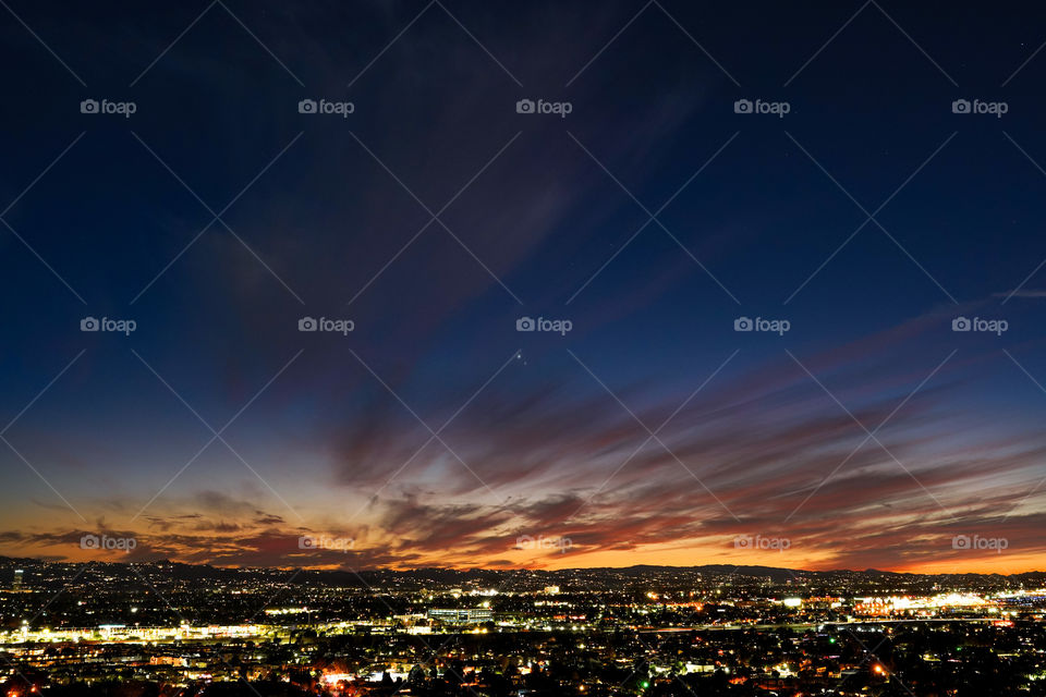 Sunset sky and city lights landscape 