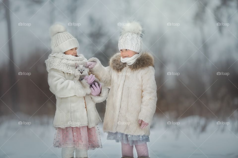 Little girls portrait with Tibet kitten at winter