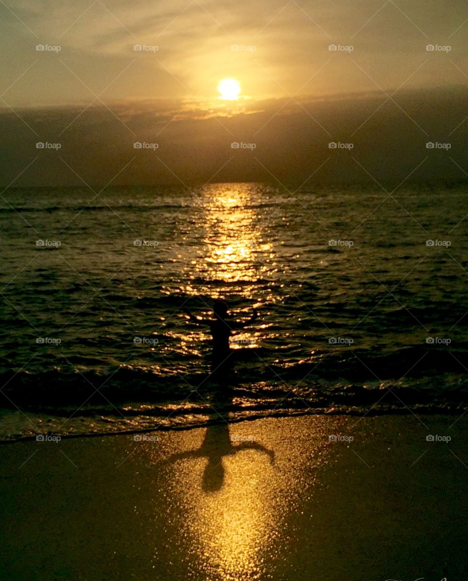 This was taken early during morning sunrise as a child played with his own shadow on the golden sand