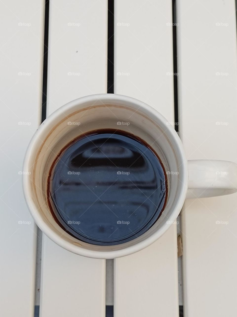 Top view of black coffee in white cup