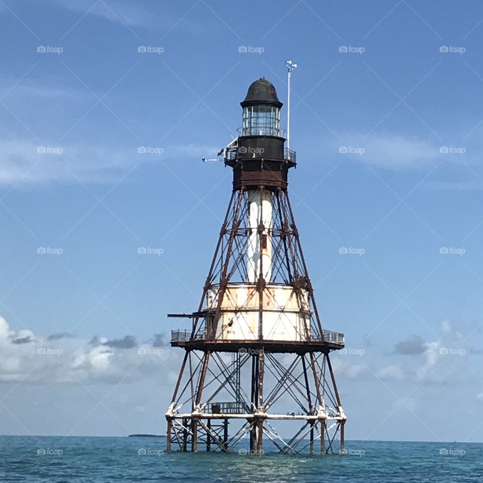 Lighthouse in front if a bright blue sky