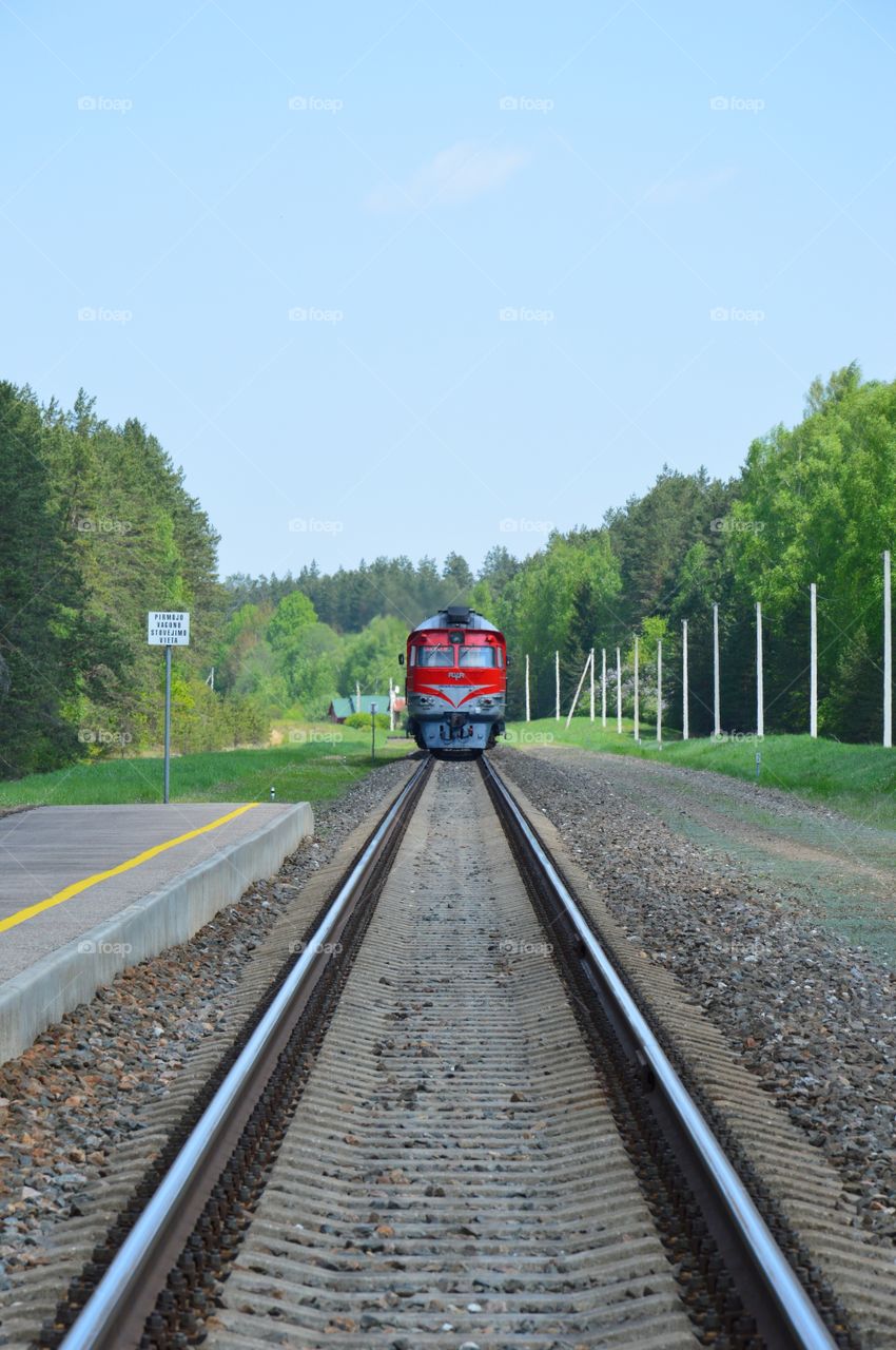 train in rural environment leaving train station