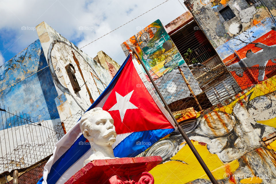 Cuban Flag and Graffiti . Looking up at wall with graffiti in Havana Cuba 