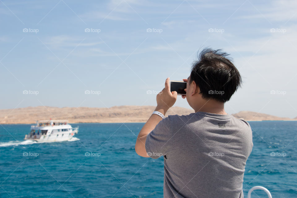 A tourist capturing some mobile photos