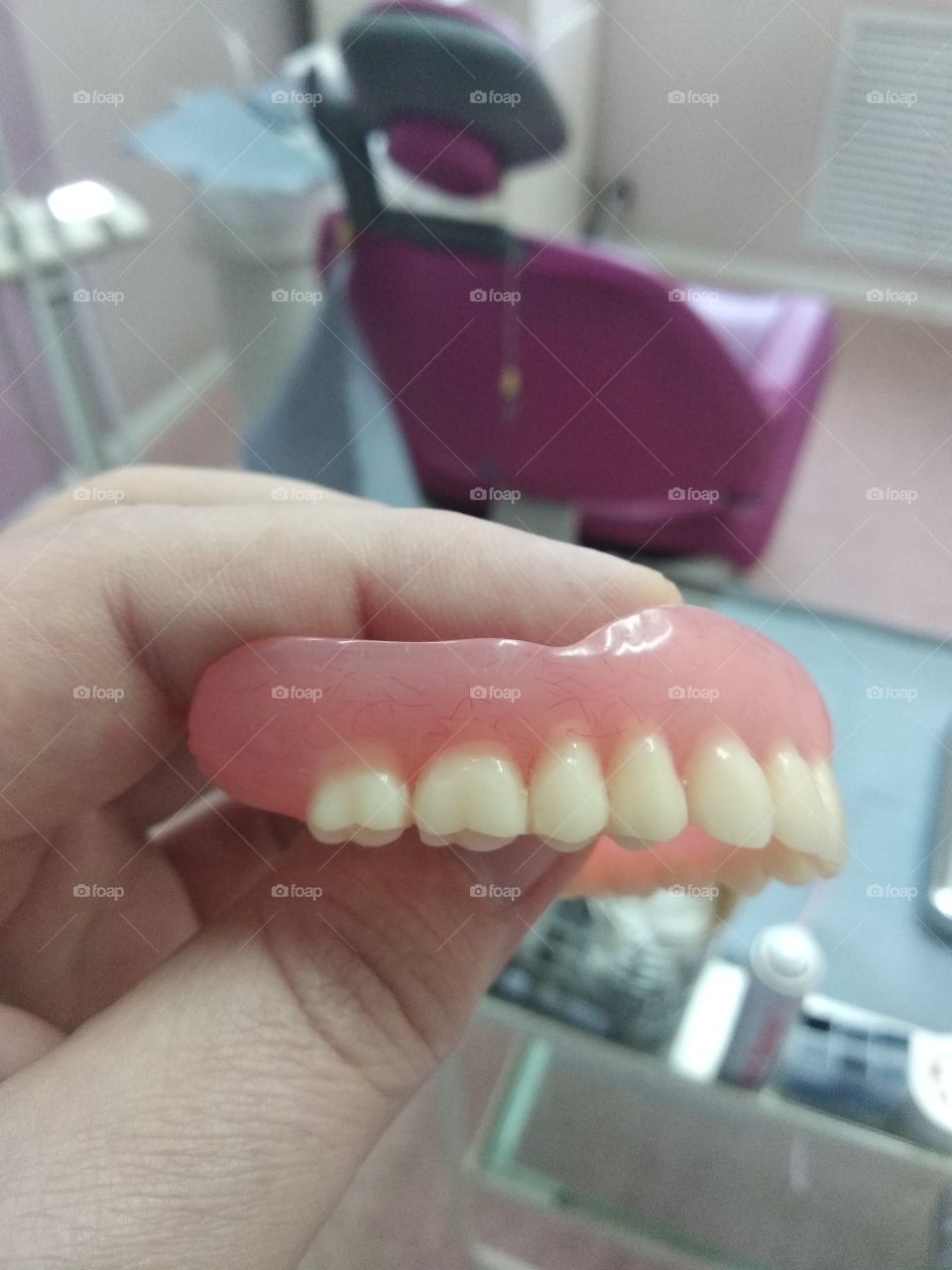 Dental denture in hand