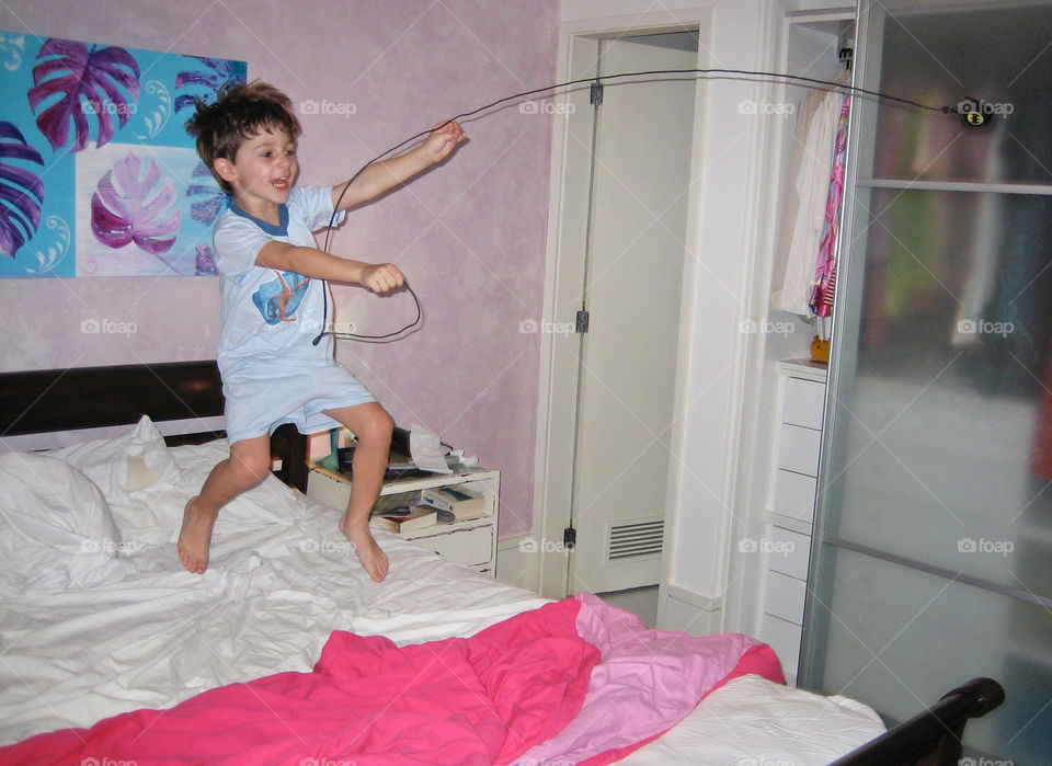 Boy Playing in Bed