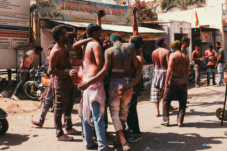 A group of friends celebrate holi festival in Pushkar, India.