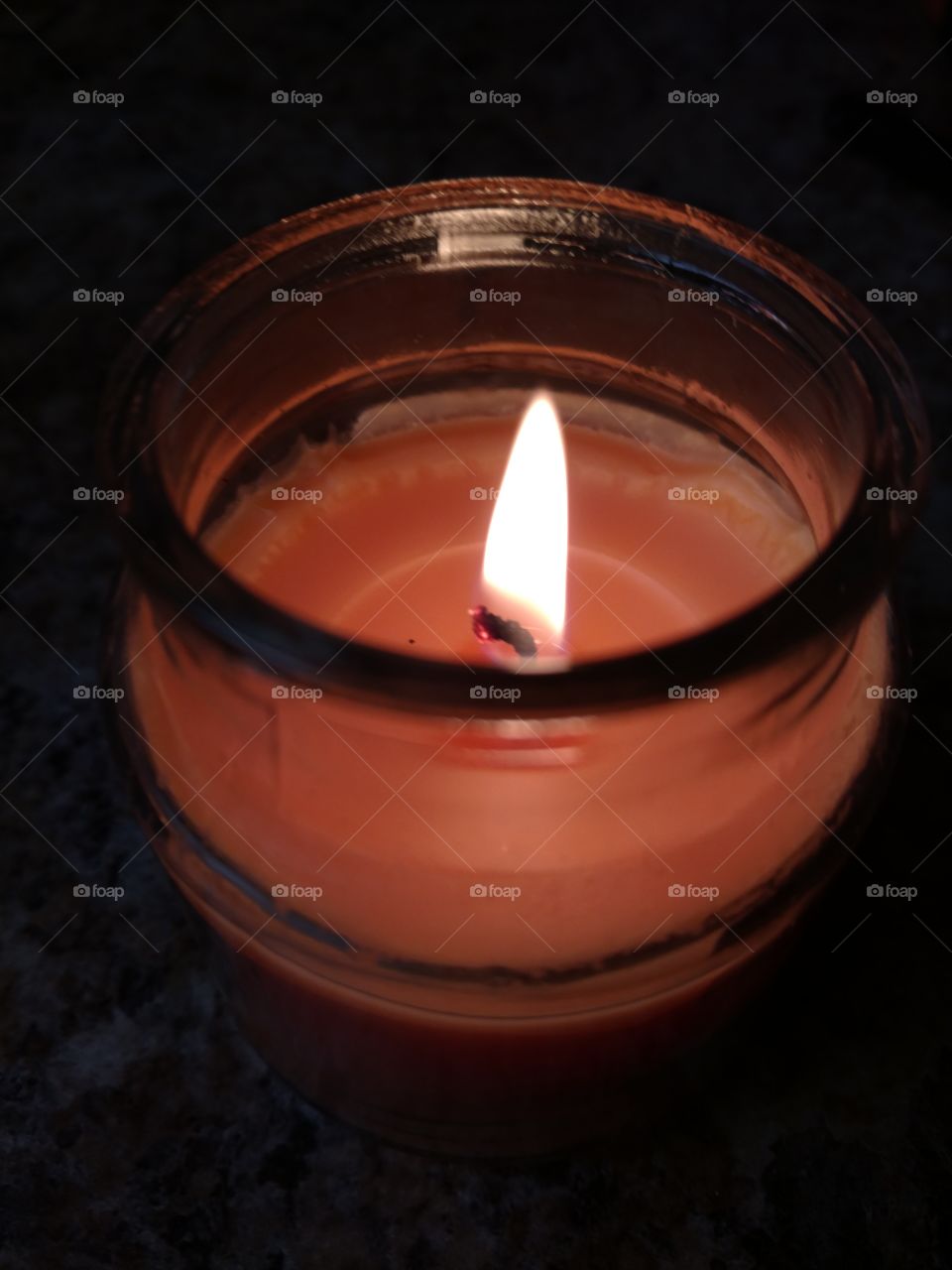Orange candle emitting ambient glow