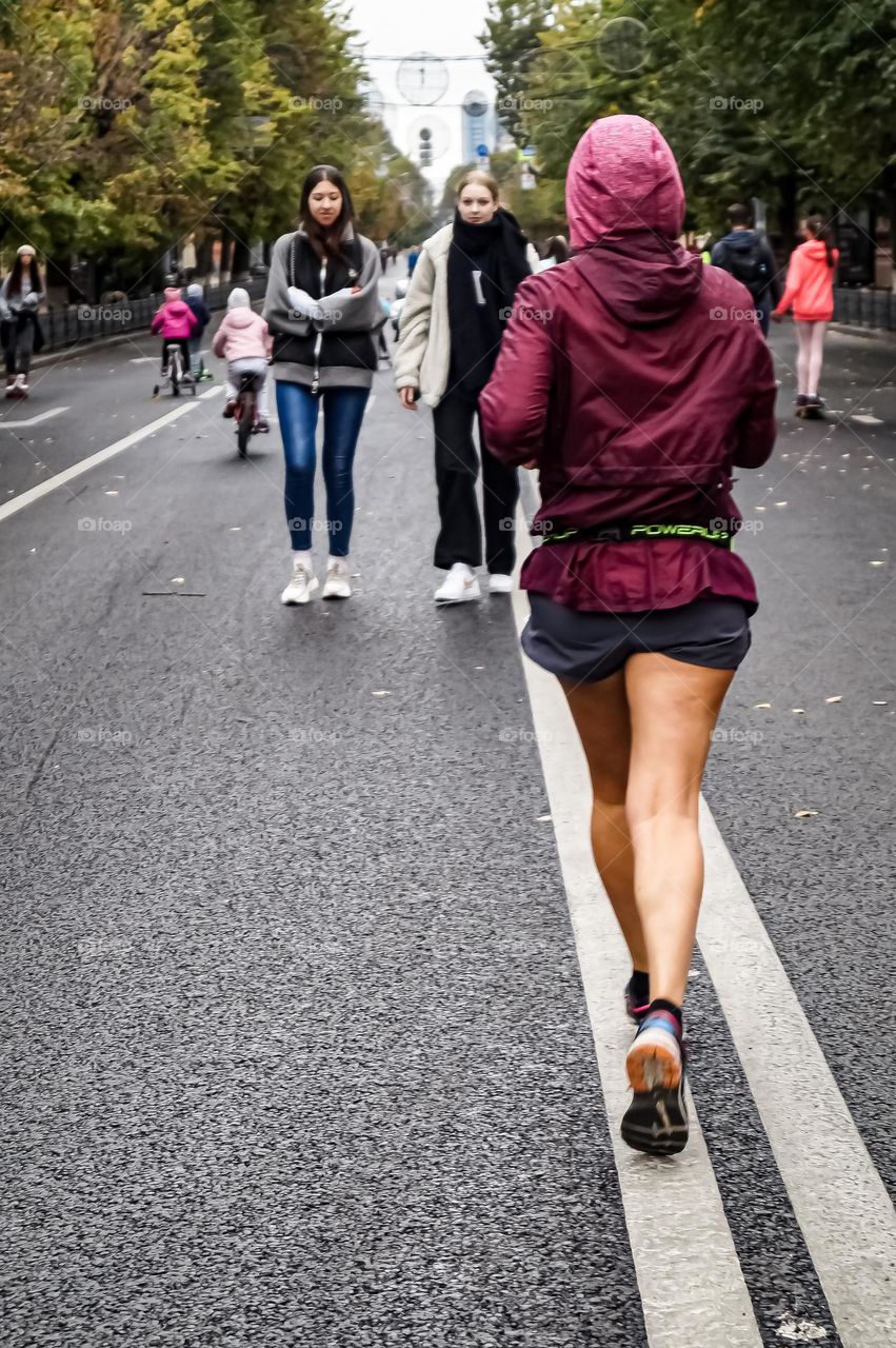 The girl runs through the streets of the city