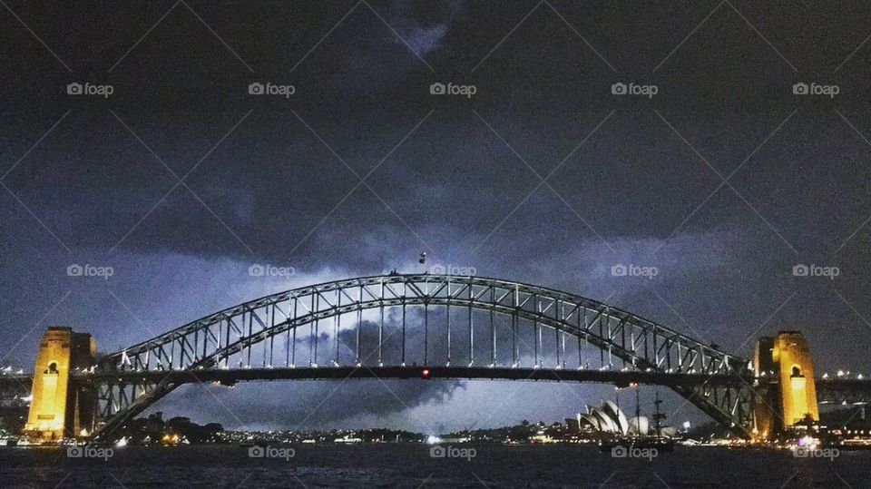 Watching the lightening strike Sydney over the Sydney opera house and the Sydney harbour bridge with a ship sailing by