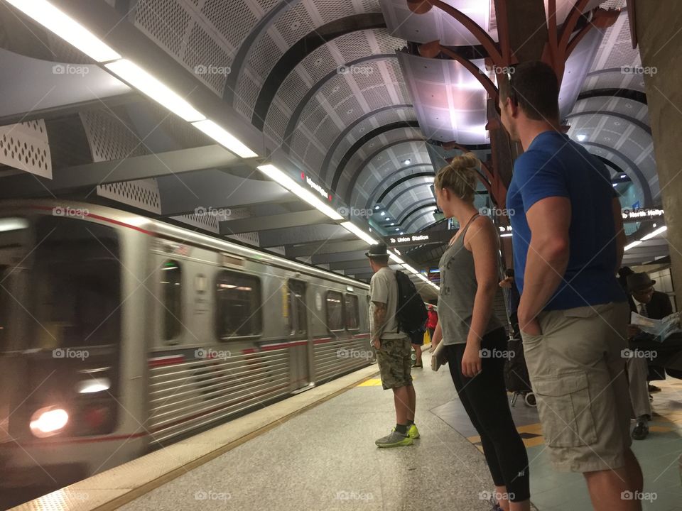 Subway riders wait for the Metro Red Line train to arrive in Hollywood, California. 