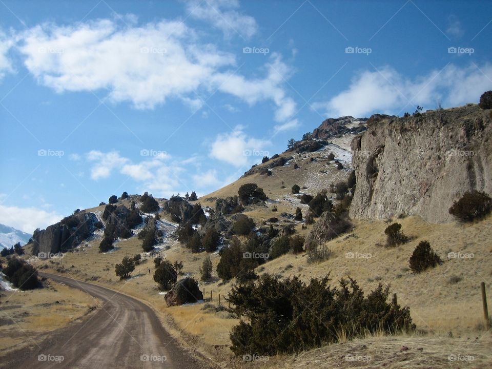 open dirt road through the mountains. open dirt road through the mountains