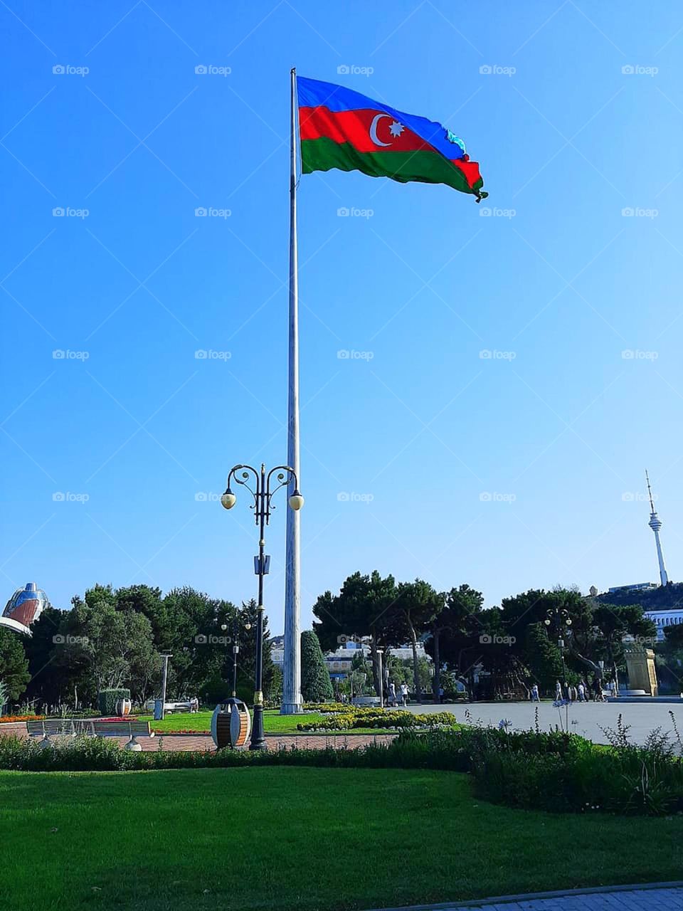 Flag of Azerbaijan on a flagpole.  "Azneft" square