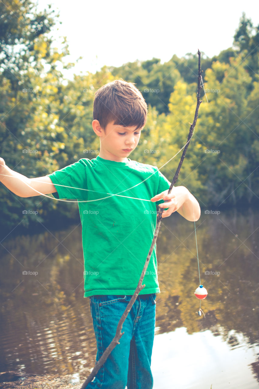 Young Boy Untangling His Fishing Line