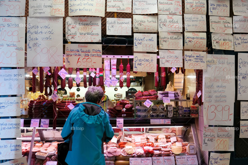 Woman buying by a butcher
