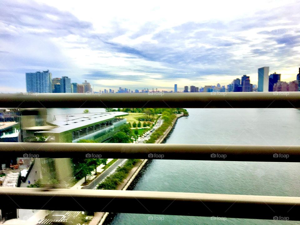 A view into the far distance from the top of the Pulaski Bridge at Newtown Creek in Long Island City, Queens, NY photographed on a cloudy afternoon in the winter of 2019 clearly shown by the snow on the metal railing. Hypnotic Productions