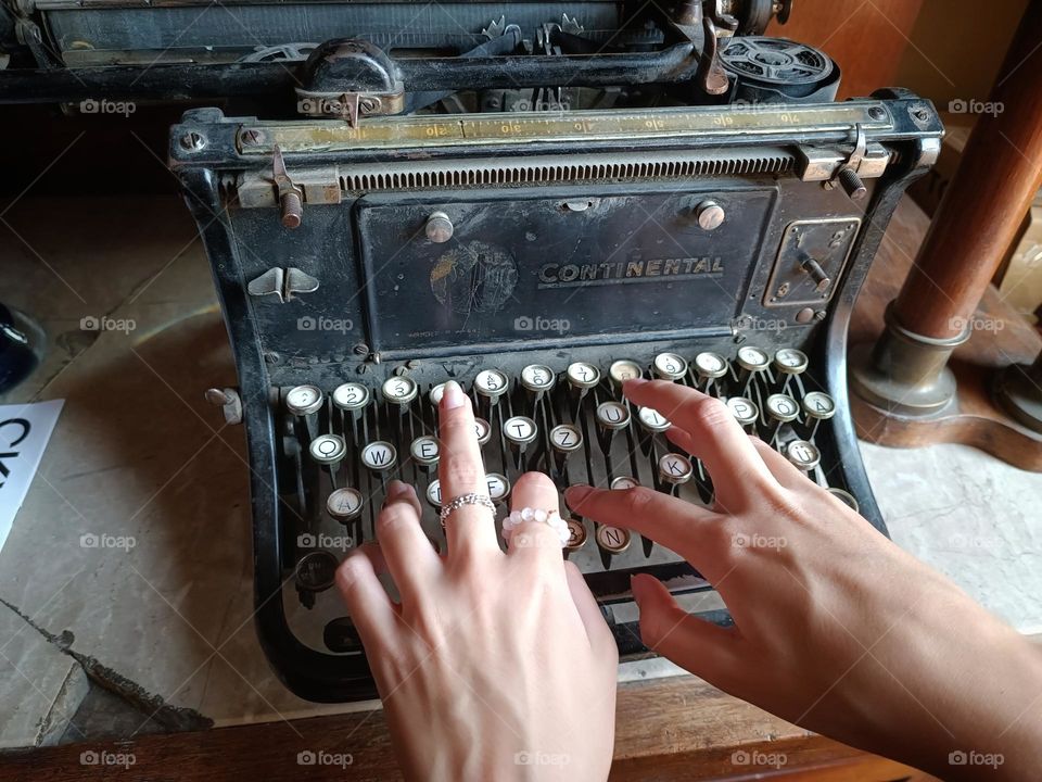 A girl typing on an antique typewriter