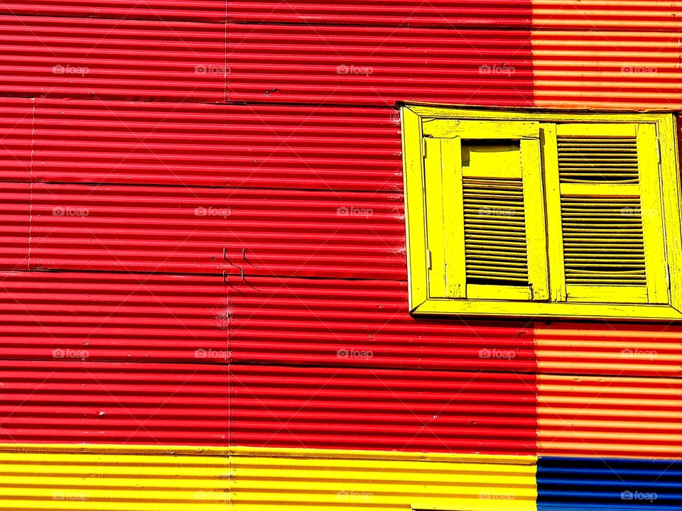 colour splash. yellow window on a red wall