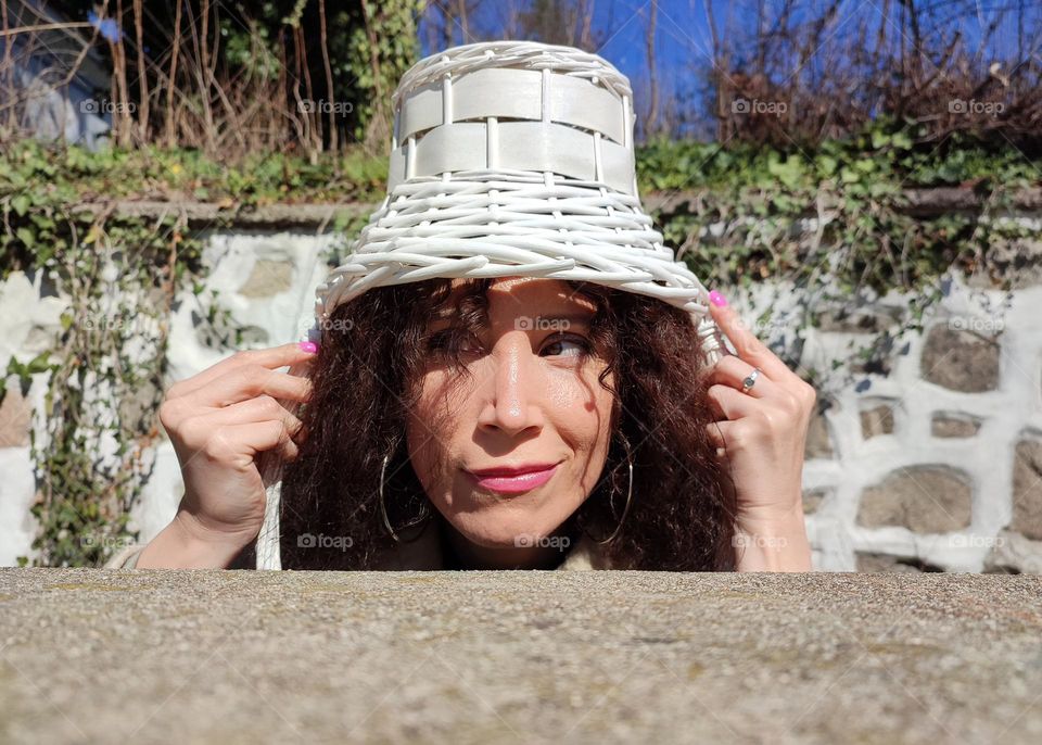 Funny Portrait of Young Woman Posing With Basket on Head, Smiling with Happy Face