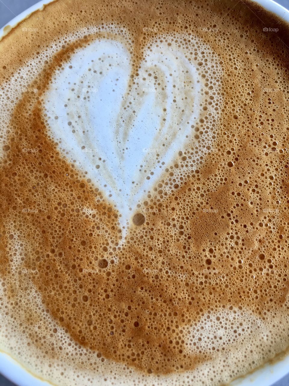 Closeup heart shape froth foam in coffee 