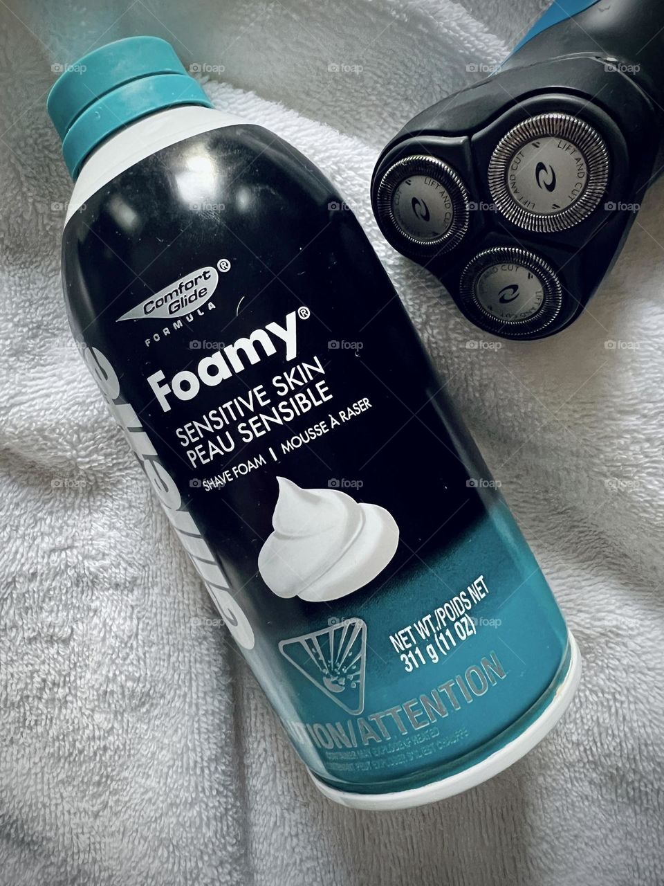 Gillette Foamy sensitive skin against white background and electric shaver