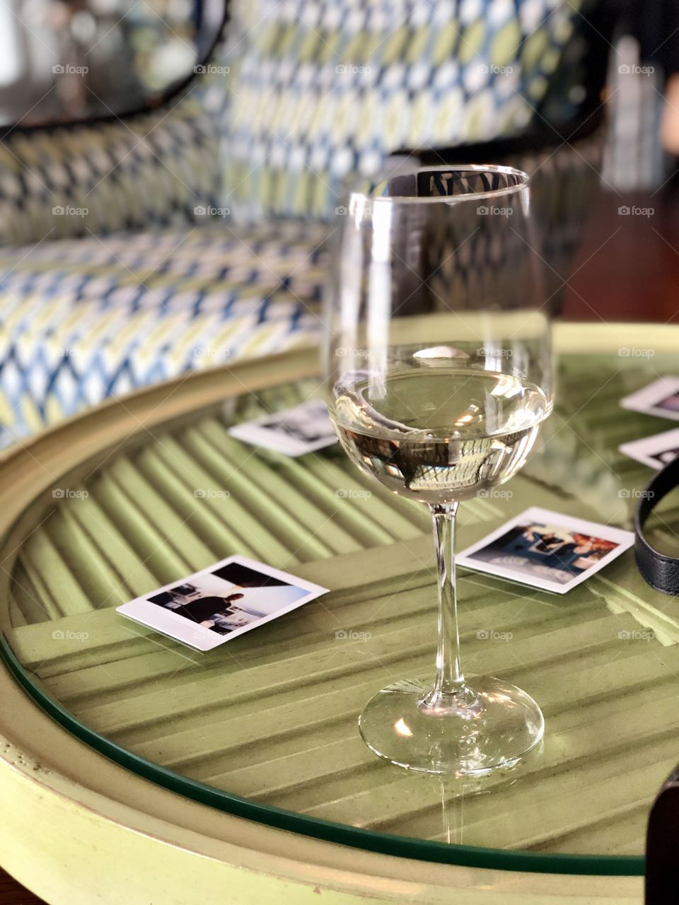 Family photographs on a table with a glass of wine