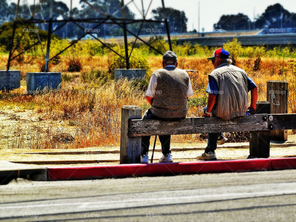 Two old men sitting on a bench