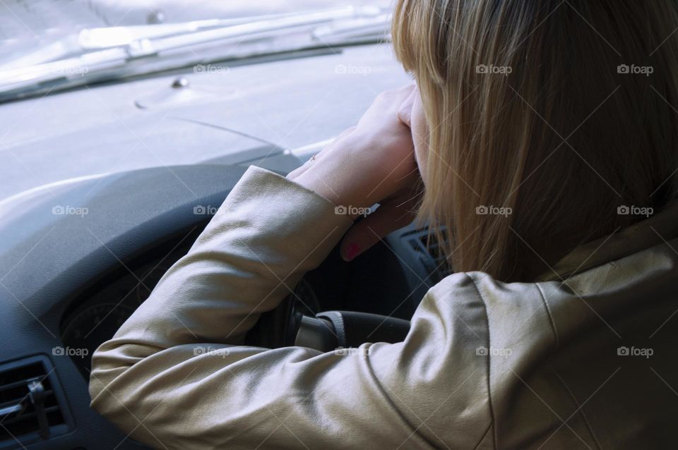 A girl rides in a car on the road