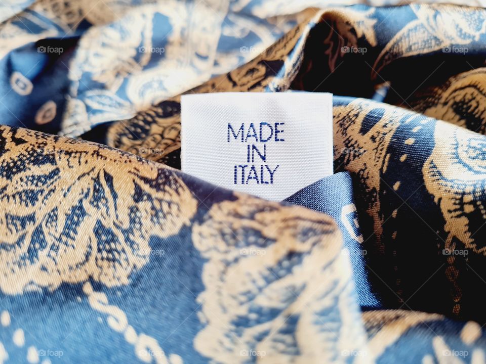 written made in italy on blue silk foulard