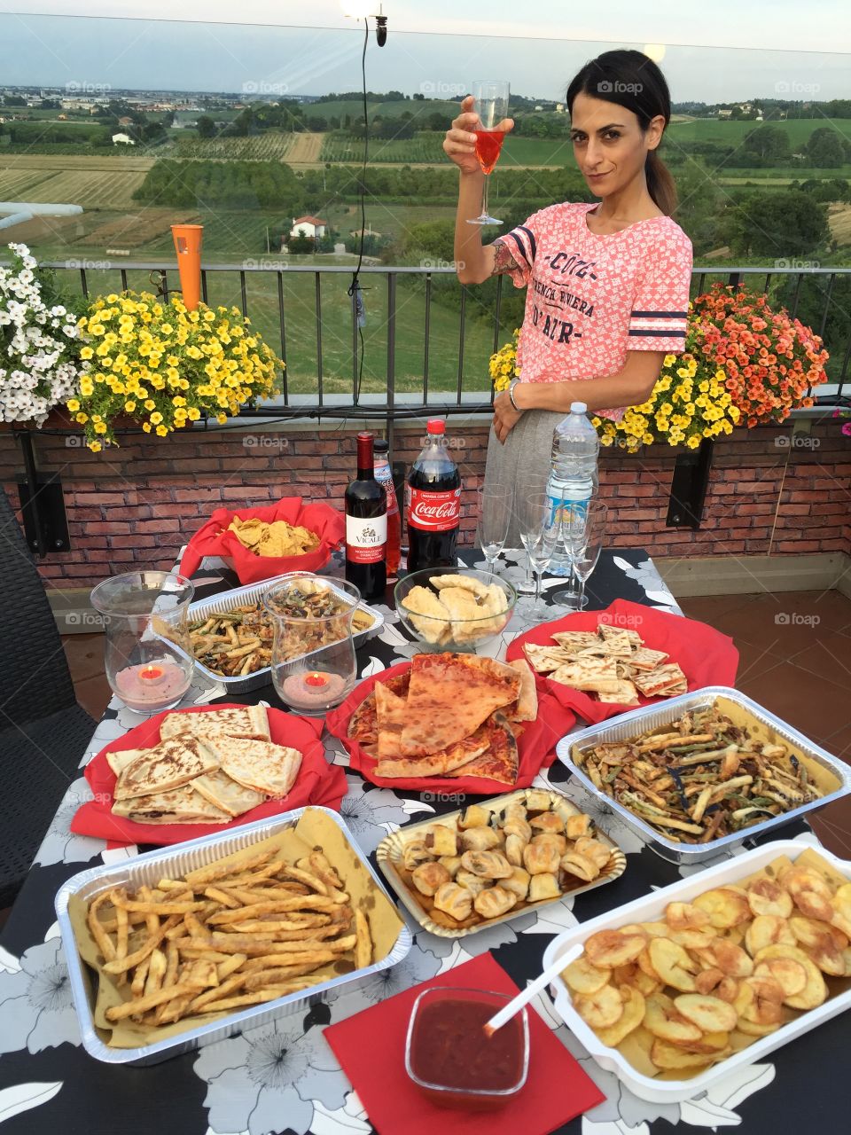 Happy hour and food. A woman is happy her full table food