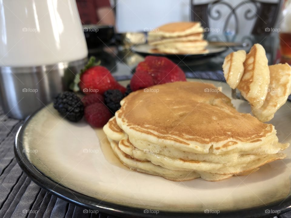 Pancakes with side of fruit and coffee