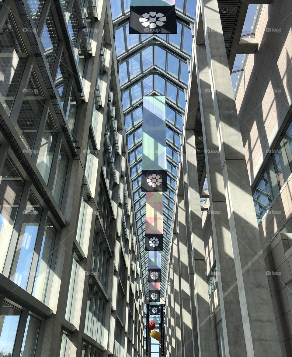 Inside a modern building full of glass and the shadow from the sunlight 