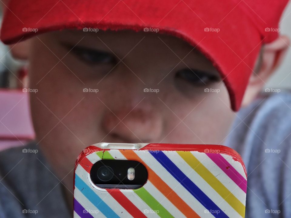 Child With Smartphone. Young Boy Immersed In The Internet
