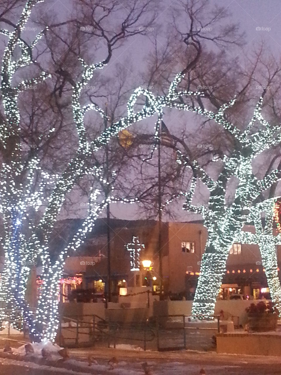 Cross lit with holiday lights in Taos Plaza, New Mexico