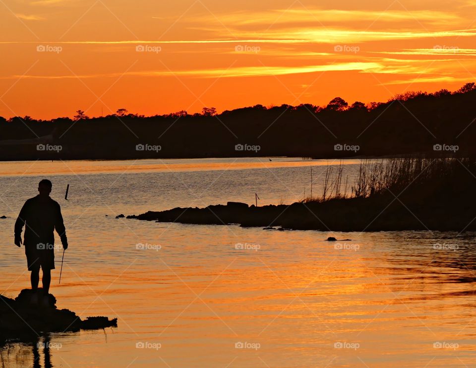 
Sunset on the bay. The yellow ball of fire changed to hues of orange, yellow and then tangerine. It merged with the sky.