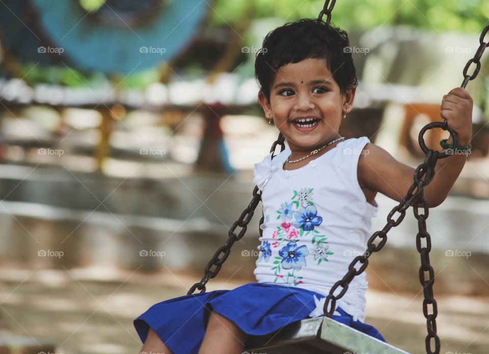 Happy Indian kid playing in a park