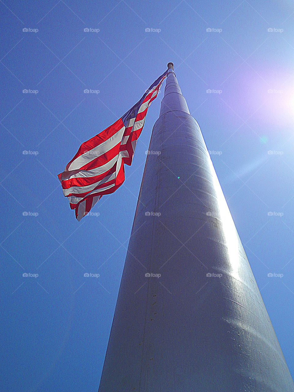 American Flag by Foap Missions - United States of America Flag Colors - White signifies purity and innocence, Red, valor and bravery, and Blue (the broad band above the stripes) signifies vigilance, perseverance & justice - Vertical  pole shot