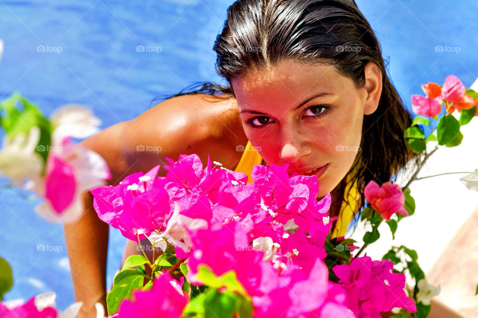 Woman with flowers in the pool