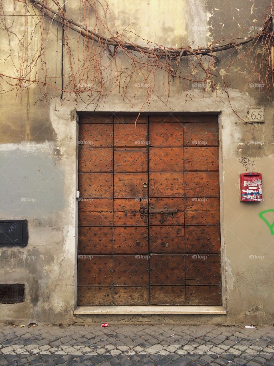 Double doors on a street in Italy.