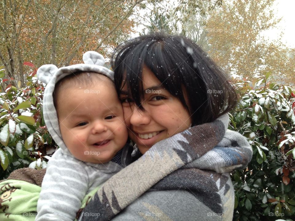 Snow day. Mom and baby in the snow 