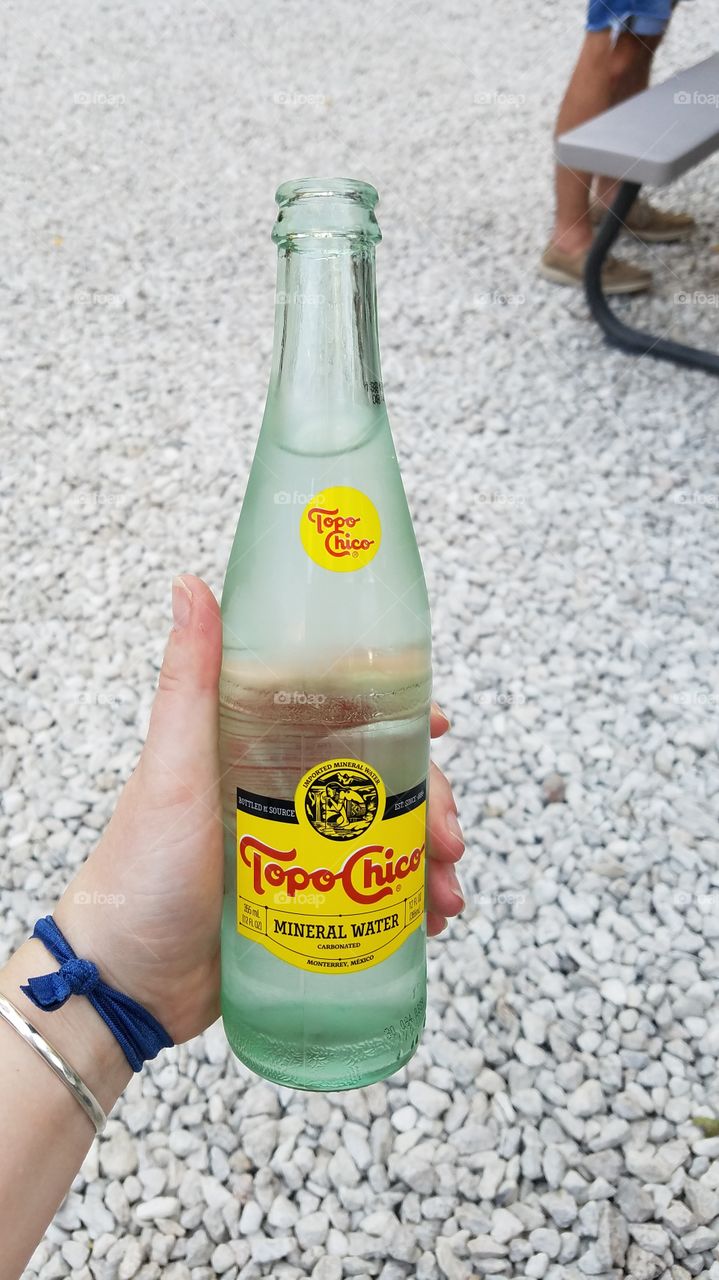 Topo Chico Bottle Held in Hand